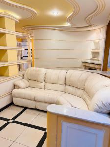 a living room with a white couch in a room at Síute com varanda gigante - Perto da USP in Sao Paulo +38 photos