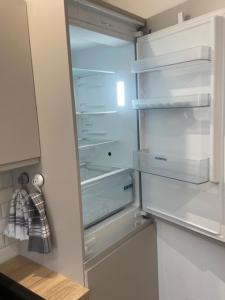 a refrigerator with its door open in a kitchen at Studio Jeanine in Le Portel