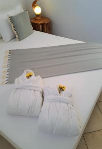a pair of towels sitting on a bed at YouGa Nest in Vívlos