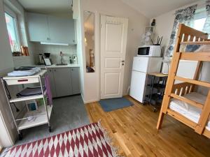 a small kitchen with a refrigerator and a ladder in a room at Sussi`s Guesthouse in Kungshamn