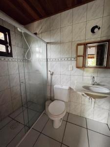 a bathroom with a toilet and a sink at Casa Ilhabela vista Mar Perequê in Santos +23 photos
