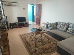 a living room with a couch and a coffee table at Apartment Sama Beach in Hurghada