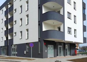 a large building with a blue and white facade at Apartman Sofija in Teslić