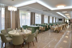 a row of tables and chairs in a restaurant at Ивелия Хотел и Спа - Ivelia Hotel & SPA in Dŭbnitsa
