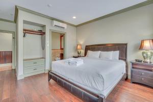 a bedroom with a large bed with white sheets at McDonough's Inn Unit 1 by Lucky Savannah in Savannah