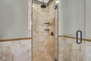 a bathroom with a shower with a glass door at McDonough's Inn Unit 1 by Lucky Savannah in Savannah