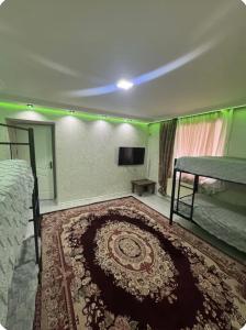 a bedroom with a bed and a rug at Yagmur Hostel in Baku