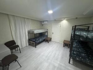 an empty room with two bunk beds in it at Yagmur Hostel in Baku