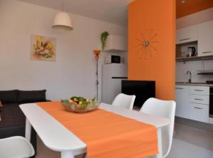 a dining room table with a bowl of fruit on it at Apartments Near Sea Supetar in Supetar