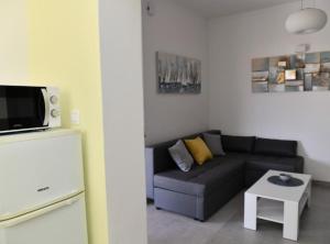 a living room with a couch and a table at Apartments Near Sea Supetar in Supetar
