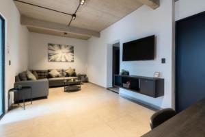 a living room with a couch and a tv on a wall at Zielo Rentals Palma ,Private balcony, Rooftop Walk to Zocalo in Mexico City