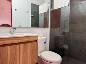 a bathroom with a toilet and a sink and a shower at Finca cafetera para descanso in Fredonia +23 photos