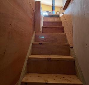 a set of wooden stairs in a room at El ático in Barra de Portezuelo