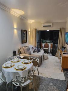 a living room with a couch and a table at Flat Mar Premium 1408 in Fortaleza
