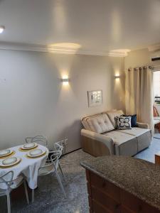 a living room with a couch and a table at Flat Mar Premium 1408 in Fortaleza +4 photos