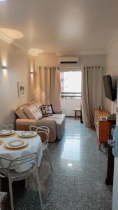 a living room with a bed and a couch and a table at Flat Mar Premium 1408 in Fortaleza