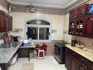 a kitchen with a sink and a counter top at Apartment Zayed moon-trip in Sheikh Zayed +3 photos