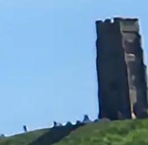 a tall building on top of a hill at BEE GENTLE BEE KIND BEE HAPPY rooms in Glastonbury