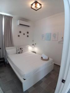 a white bed in a room with a mirror at V1 Pr Rentals Big Apartment For Groups in San Juan +74 photos