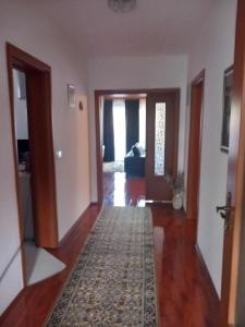 a living room with a hallway with a rug at Stan na dan Vila Dizdar in Goražde