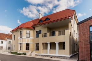 a building with a red roof on a street at Stylish Apartment in Historic Villa Doll, City Center in Viljandi