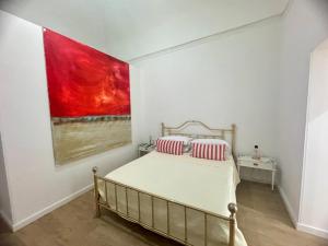 a bedroom with a bed and a painting on the wall at META CC PALACE with pool in Meta