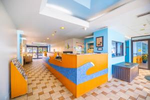 a restaurant with a colorful counter in a room at Four Sails Resort in Virginia Beach +41 photos