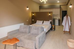 a hotel room with a bed and a couch at Rookhe Kazbegi in Kazbegi