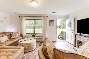 a living room with a couch and a table at Dog Friendly, Screened Porch St Stephen Retreat! in Saint Stephen