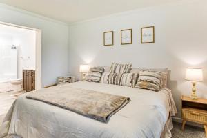 a white bedroom with a large bed with two pillows at Dog Friendly, Screened Porch St Stephen Retreat! in Saint Stephen