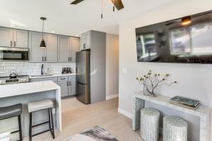 a kitchen with white cabinets and a stainless steel refrigerator at Newly Updated! Commuter-Friendly Anaheim Home in Anaheim
