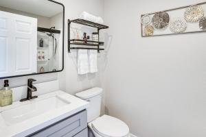 a bathroom with a sink and a toilet and a mirror at Newly Updated! Commuter-Friendly Anaheim Home in Anaheim +18 photos