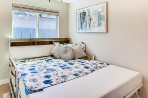 a small bedroom with a bed and a window at Newly Updated! Commuter-Friendly Anaheim Home in Anaheim