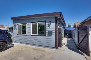 a tiny house in a driveway with a garage at Newly Updated! Commuter-Friendly Anaheim Home in Anaheim