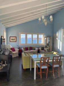 a living room with a table and a couch at Views on Venice Lagoon in Lido