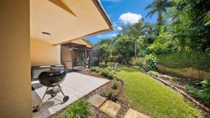 a backyard with a grill on a patio at Luxury Queen Room, Walk to UM, Free Car Service! in Miami