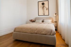 a bedroom with a bed in a white room at Stylish Apartment in Historic Villa Doll, City Center in Viljandi