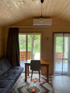 a room with a couch and a table and a chair at Chalet Ivanna in Dilyatyn