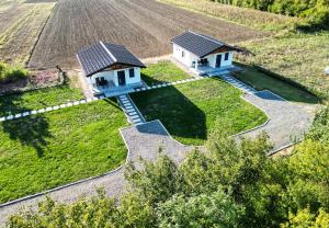 an aerial view of two houses in a field at Sunny Apartments in Malo Laole