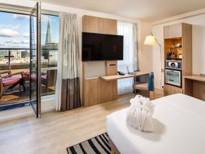 a hotel room with a bed and a large window at Novotel London Blackfriars in London +127 photos