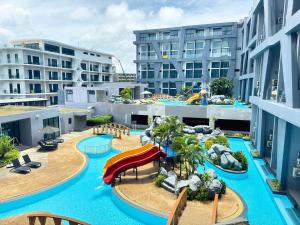 a resort with a water park with a slide at Utopia Loft Condo Naiharn Beach in Nai Harn Beach