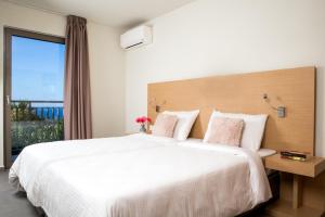 Postel nebo postele na pokoji v ubytování Sundance Apartments & Suites