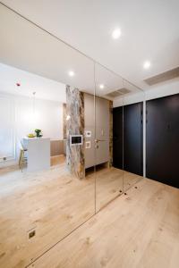 an empty room with glass walls and wood floors at Vidok 201 in Olsztyn +9 photos