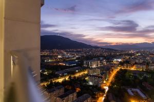 a view of a city at night at Golden-Hour Loft 35F Sunset Views Free Parking in Gorno Lisiče