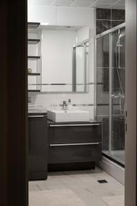 a bathroom with a sink and a mirror at Golden-Hour Loft 35F Sunset Views Free Parking in Gorno Lisiče