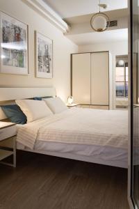 a bedroom with a large white bed and a mirror at Golden-Hour Loft 35F Sunset Views Free Parking in Gorno Lisiče