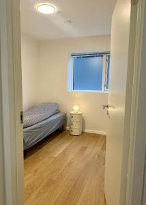 a small bedroom with a bed and a window at New apartment in Hoyvík in Hoyvík