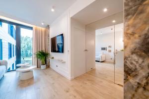 a bathroom with white walls and a large window at Vidok 201 in Olsztyn