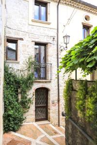 a brick house with a door and a balcony at Residenza Sant'Andrea in Campobasso