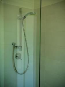 a shower with a glass door in a bathroom at L'introvabile in Cesena